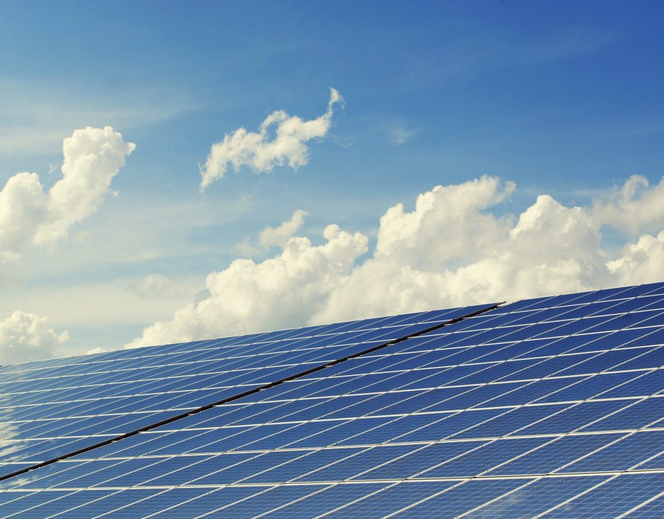 solar panels and blue sky with clouds