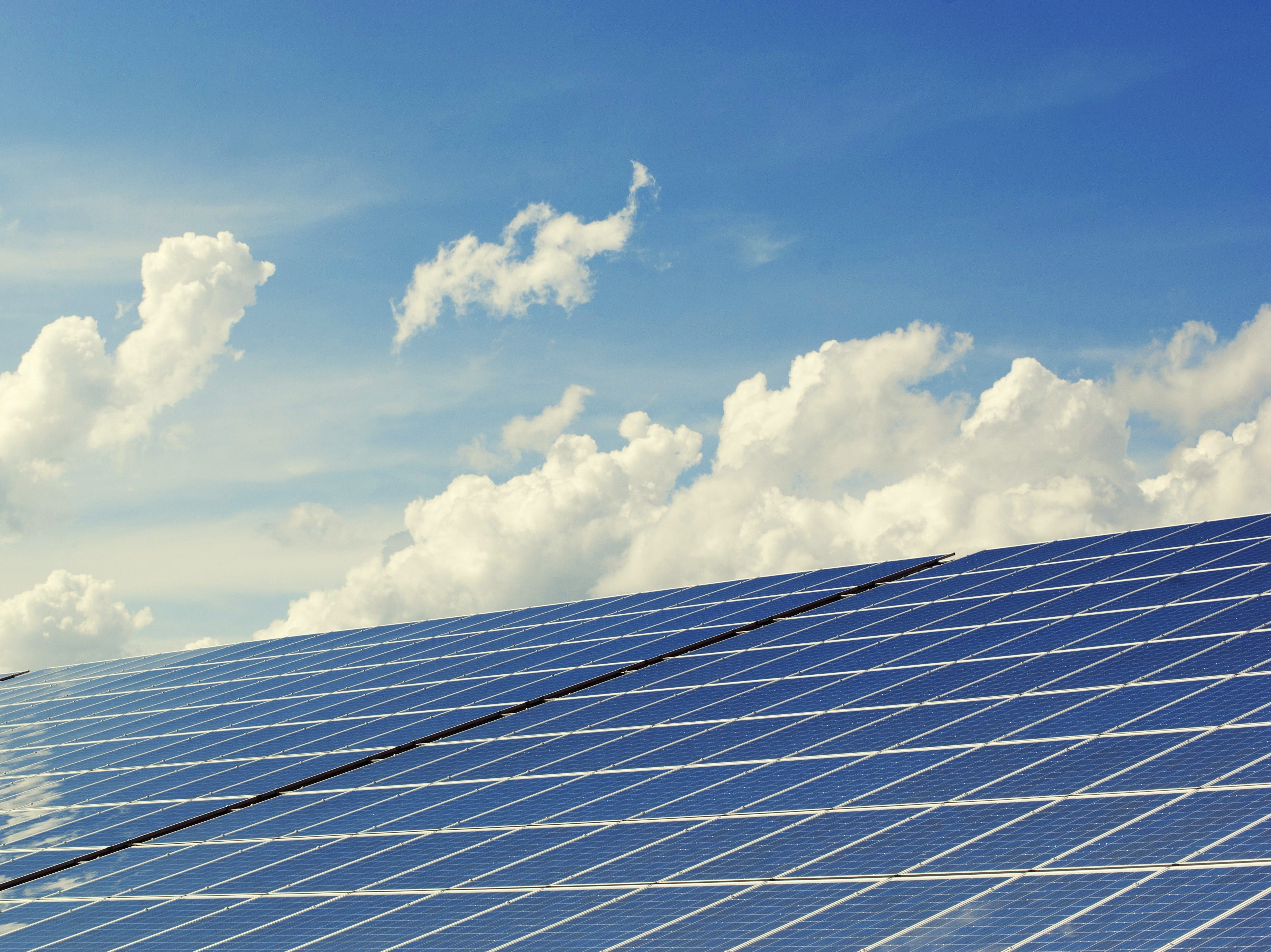 solar panels and blue sky with clouds